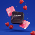 CHOOVY Nightfall tin floating on a deep blue night backdrop with raspberries and pink strip sachets